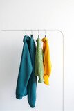 Bright colorful collection of clothes on a rack. Fashion concept