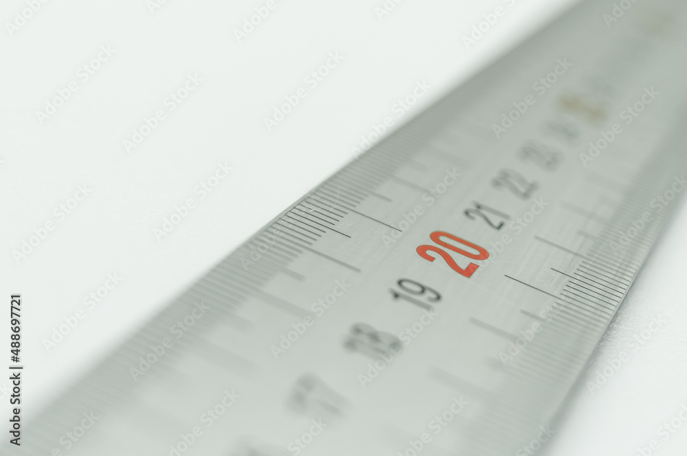 Iron ruler close-up on a white background. Stainless steel ruler. Working tools made of metal and stationery. Selective focus, isolated on white Iron ruler close-up on a white background. Stainless steel ruler. Working tools made of metal and stationery. Selective focus, isolated on white