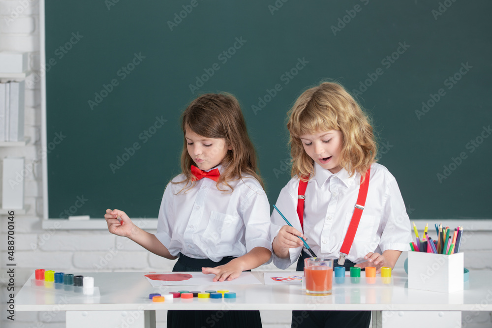 School children drawing a colorful pictures with pencil crayons in ...