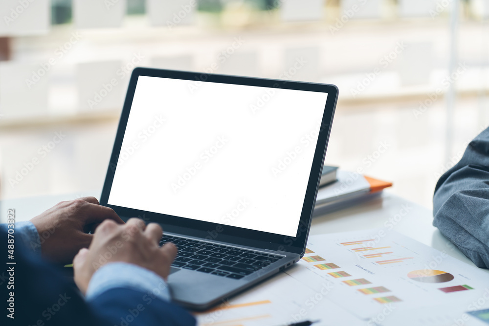 Close-up image of a male assistant working on laptop computer at her workspace. laptop blank screen mockup. Close-up image of a male assistant working on laptop computer at her workspace. laptop blank screen mockup.