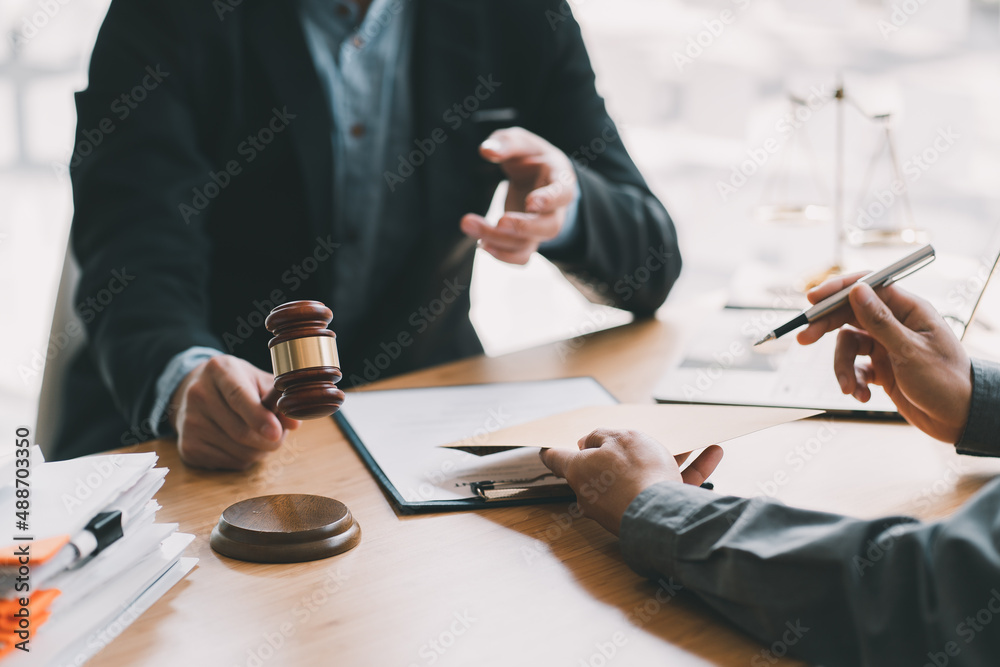 Consultation and conference of Male lawyers and professional businesswoman working and discussion having at law firm in office. Concepts of law, Judge gavel with scales of justice. Consultation and conference of Male lawyers and professional businesswoman working and discussion having at law firm in office. Concepts of law, Judge gavel with scales of justice.