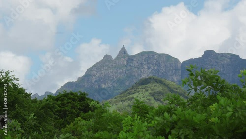 shooting from top to bottom the peaks of mountains and jungles of Mauritius, the sky in clouds photo