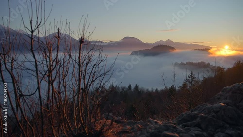 Bled Slovenia captured at sunrise with in the nature with beautiful mountains and landscapes cover in fog and nice golden hour colors filmed in  dynamic movement with a camera on a gimble photo