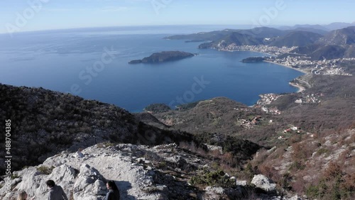 AERIAL - People visiting Fort Kosmac and the Adriatic Sea, Montenegro, reverse photo