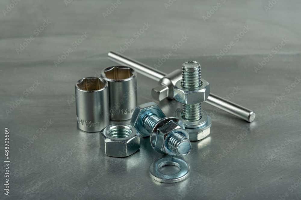 Tool for assembling threaded connections. Wrenches and heads. Close-up on the background of a metal blank. Tool for assembling threaded connections. Wrenches and heads. Close-up on the background of a metal blank.