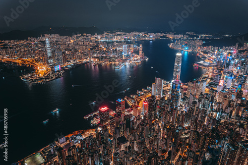 Aerial view of Hong Kong Downtown. Financial district and business centers in smart city, technology concept. Top view of skyscraper and high-rise buildings at night.