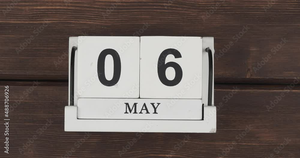 May calendar, change of days. wood calendar with date month and day on a wooden table. fast pace of time during the month. accelerated calendar. Stop motion. 