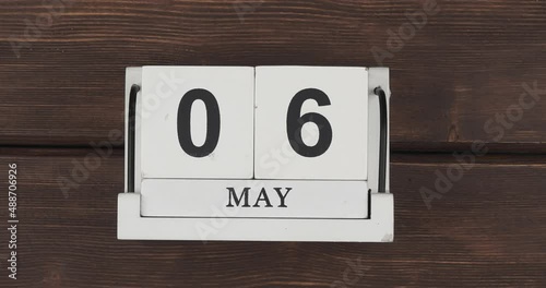 May calendar, change of days. wood calendar with date month and day on a wooden table. fast pace of time during the month. accelerated calendar. Stop motion. 