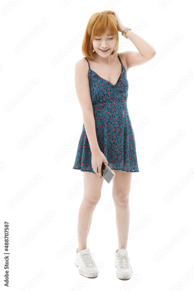 Isolated cutout studio full body shot of Asian young sexy blonde short hair female fashion model in camisole dress and sneakers standing look at camera on white background Isolated cutout studio full body shot of Asian young sexy blonde short hair female fashion model in camisole dress and sneakers standing look at camera on white background