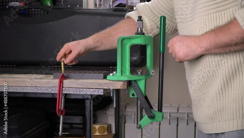 Man reloading ammo in his gun room, soft focus photo