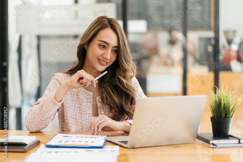 Portrait of smiling beautiful business asian woman working in office use computer with copy space. Business owner people sme freelance online marketing e-commerce telemarketing, work from home concept