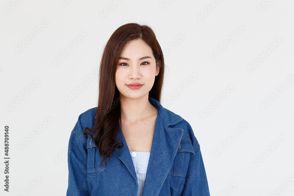 Portrait isolated cutout studio shot of Asian young happy cheerful long brown hair female teenager model in casual blue denim jeans jacket standing smiling look at camera posing on white background Portrait isolated cutout studio shot of Asian young happy cheerful long brown hair female teenager model in casual blue denim jeans jacket standing smiling look at camera posing on white background