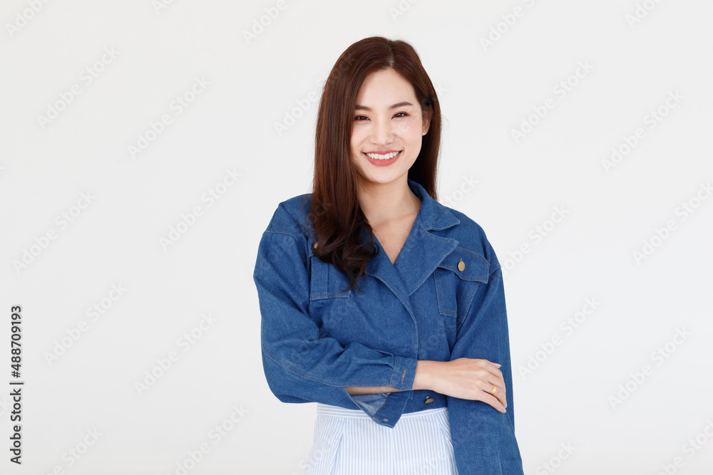Portrait isolated cutout studio shot of Asian young happy cheerful long brown hair female teenager model in casual blue denim jeans jacket standing smiling look at camera posing on white background Portrait isolated cutout studio shot of Asian young happy cheerful long brown hair female teenager model in casual blue denim jeans jacket standing smiling look at camera posing on white background