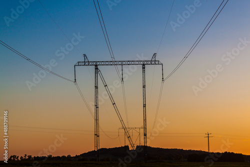 high voltage towers in the sunset