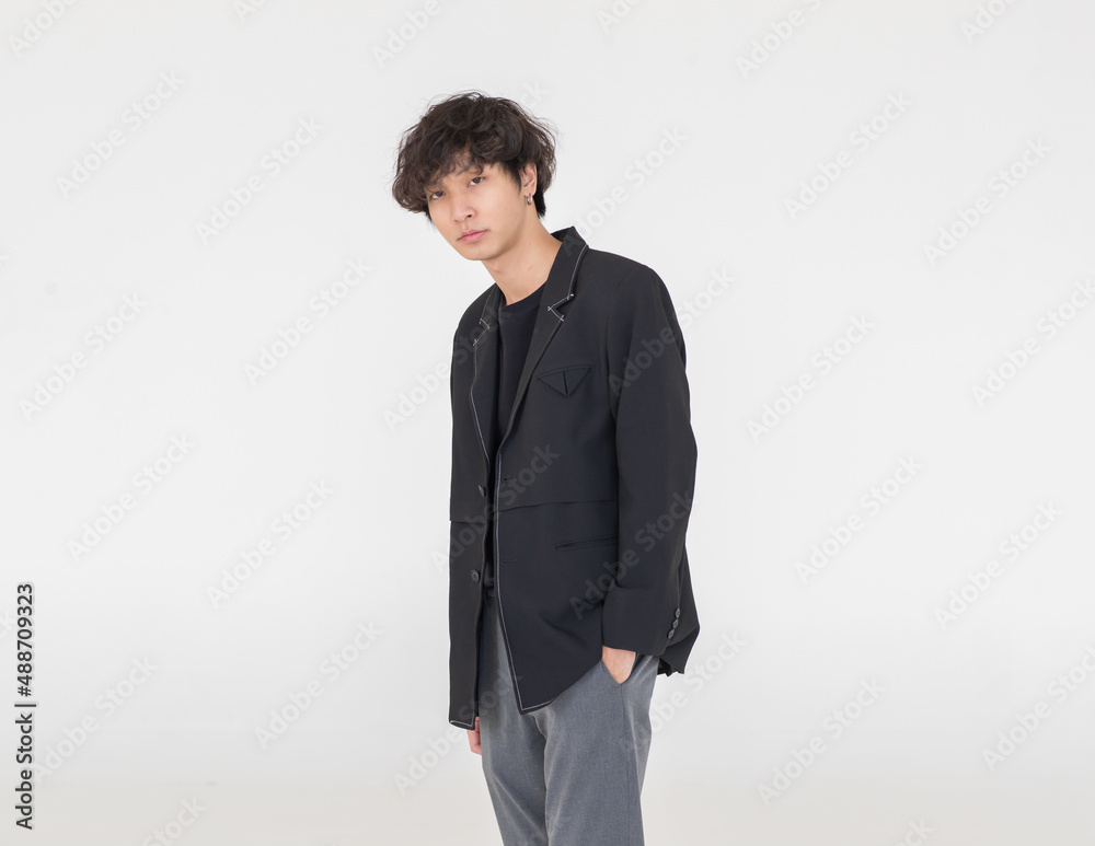 Portrait isolated cutout studio shot of Asian urban young trendy fashion stylish male model in casual hipster streetwear suit and earrings standing holding hands in pants pockets on white background Portrait isolated cutout studio shot of Asian urban young trendy fashion stylish male model in casual hipster streetwear suit and earrings standing holding hands in pants pockets on white background