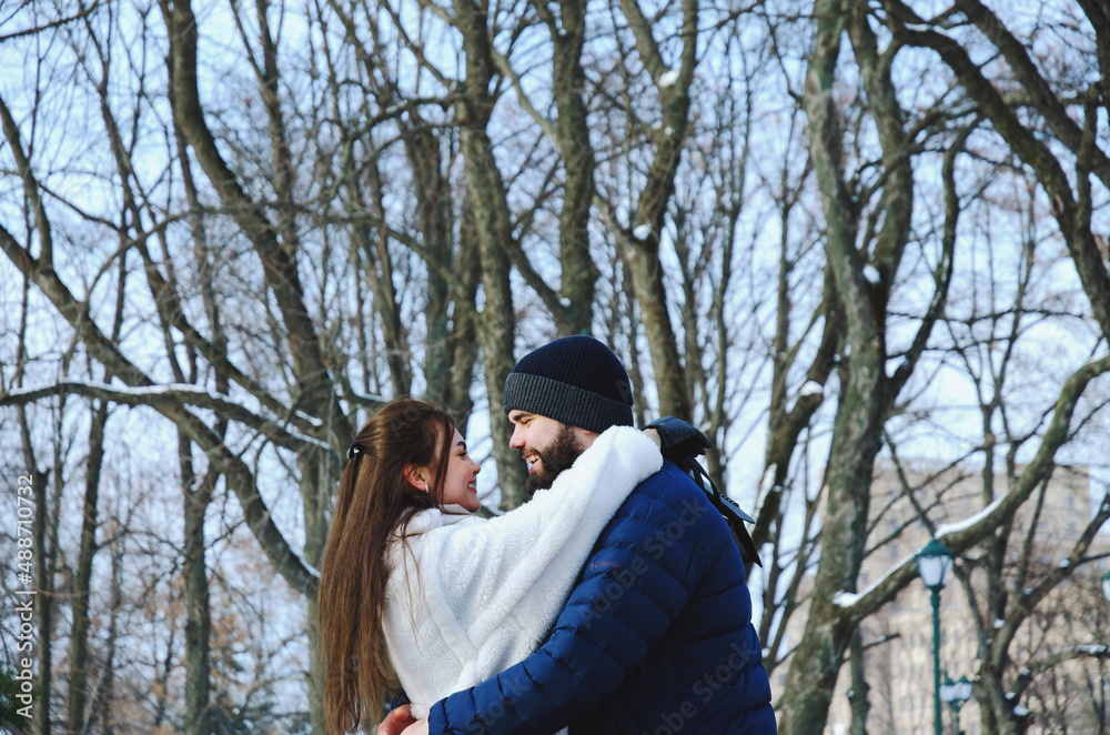 Love story of couple walking in city. Young business man in a blue jacket with a beard. And a cute woman in long coat. Family holiday and togetherness, date. Romantic Love story of couple walking in city. Young business man in a blue jacket with a beard. And a cute woman in long coat. Family holiday and togetherness, date. Romantic