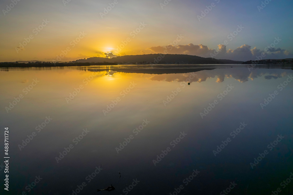 Hazy Sunrise Waterscape with Reflections