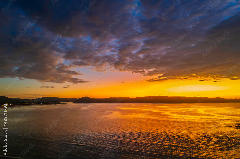 Fototapeta premium Aerial sunrise seascape with low clouds