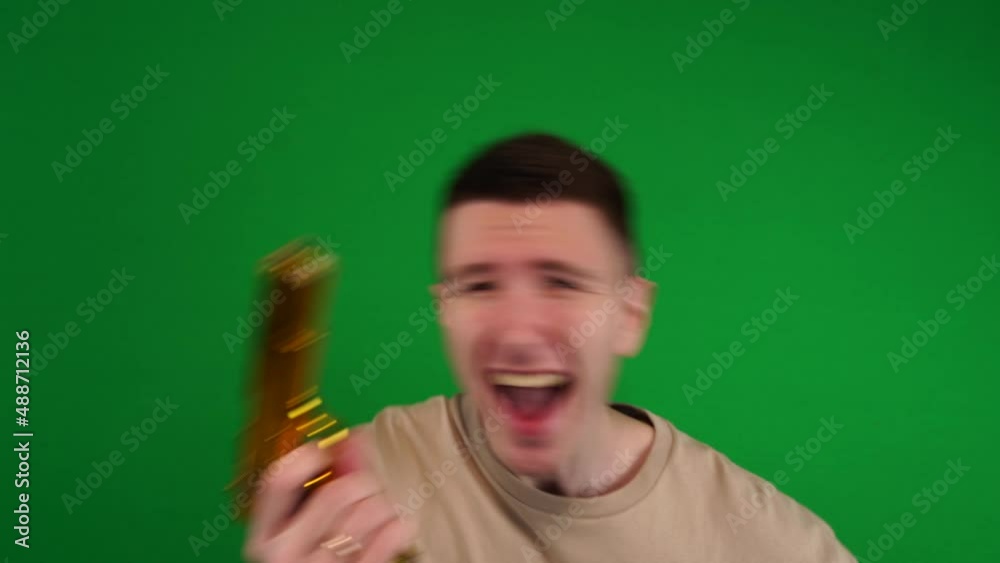 A man merrily shoots a pistol in all directions, a golden pistol, shooting on chromakey, green background A man merrily shoots a pistol in all directions, a golden pistol, shooting on chromakey, green background