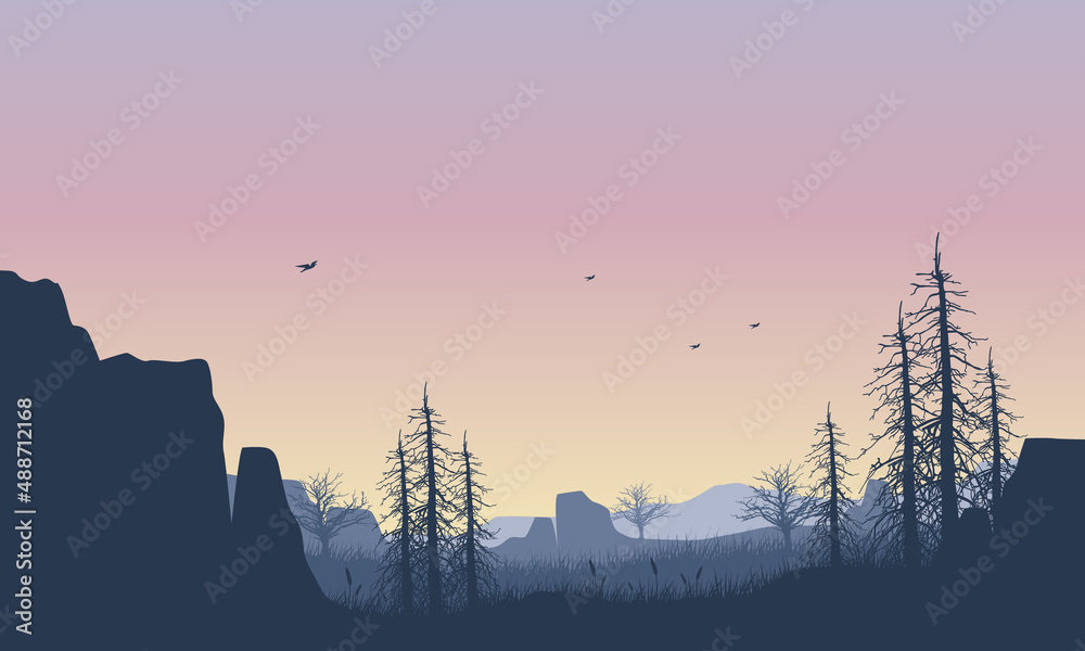 Beautiful mountain panorama at dusk with aesthetic silhouettes of dry trees and cliffs around it