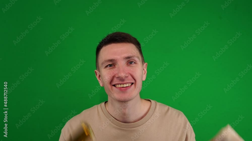 A man dances with money and a gun in his hand, shooting on a chromakey, a golden pistol, dancing with money and weapons A man dances with money and a gun in his hand, shooting on a chromakey, a golden pistol, dancing with money and weapons