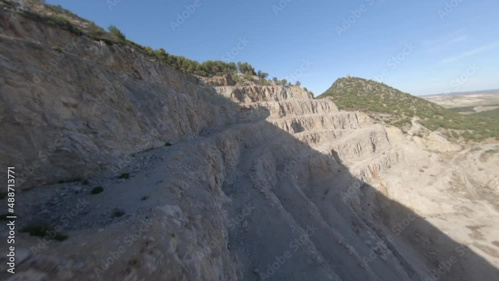 Proximity flight along tiered excavation in abandoned rock mine quarry Proximity flight along tiered excavation in abandoned rock mine quarry