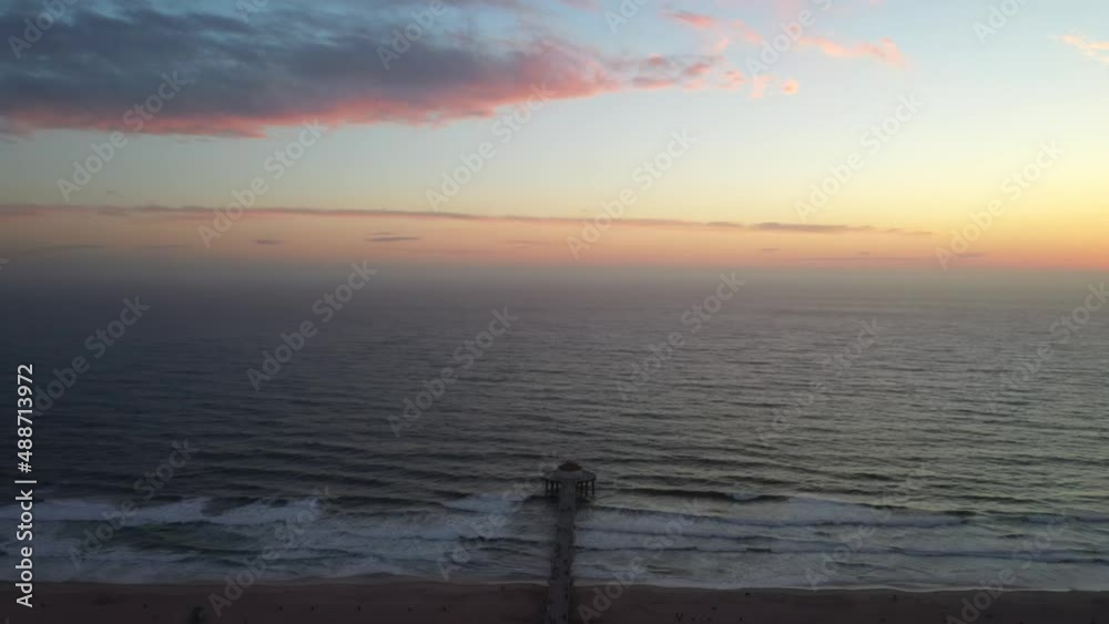 Aerial View of the Manhattan Beach Pier and Waves Breaking on the Shore - drone shot Aerial View of the Manhattan Beach Pier and Waves Breaking on the Shore - drone shot