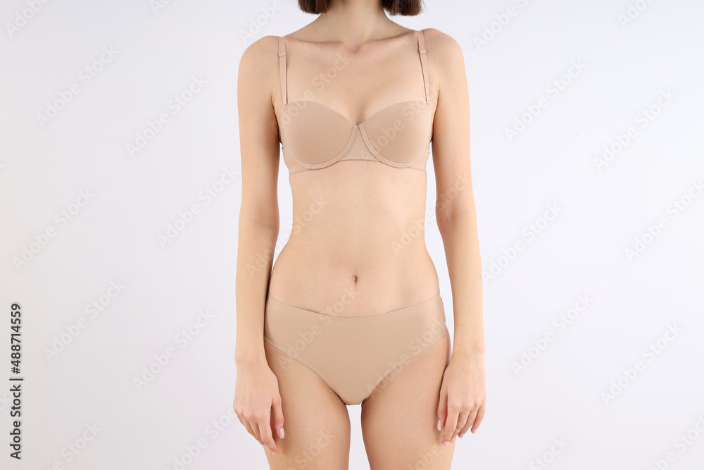 Fototapeta premium Concept of weight loss with young slim woman on light background