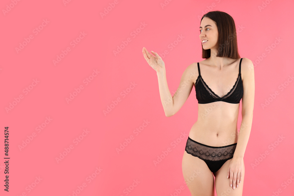 Concept of underwear with young woman on pink background