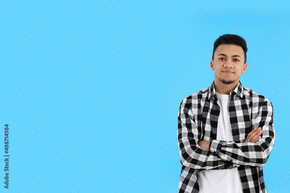 Young man in checkered shirt on blue background Young man in checkered shirt on blue background