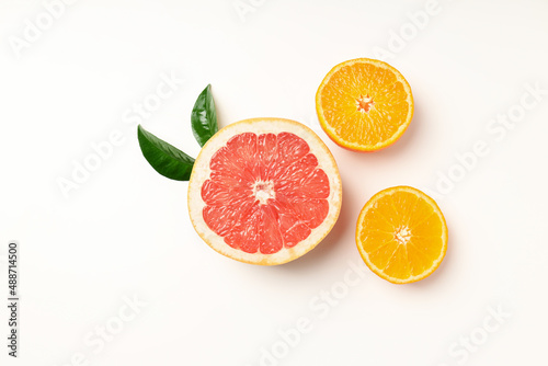 Citrus fruits with leaves on white background  top view