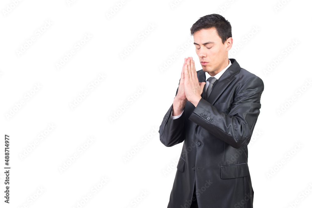 Serious man in black suit praying with clasped hands Serious man in black suit praying with clasped hands