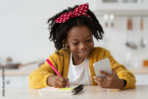 Online Lesson. Black Preteen Girl Study With Smartphone At Home