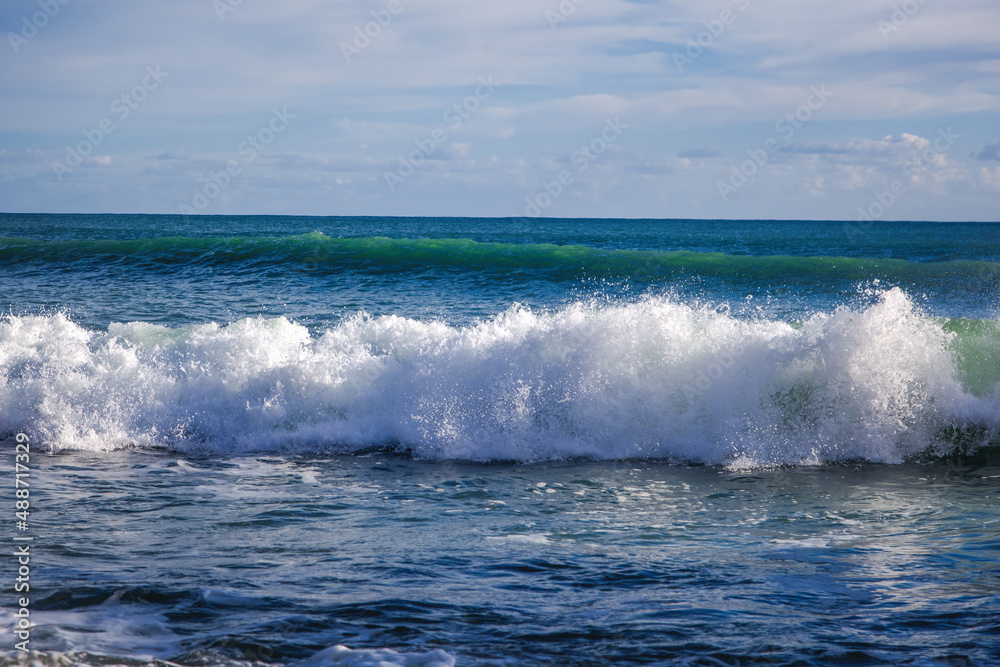 Big breaking ocean wave on the sandy beach, beautiful sea landscape, nature background