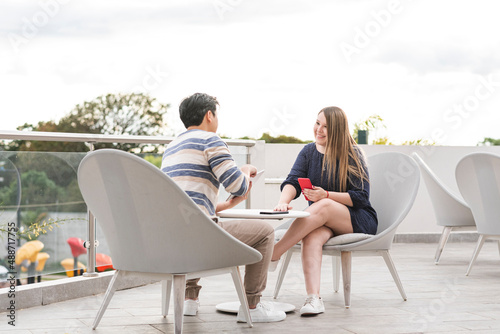 couple having a pleasant conversation on an outdoor terrace © LEONARDO BORGES
