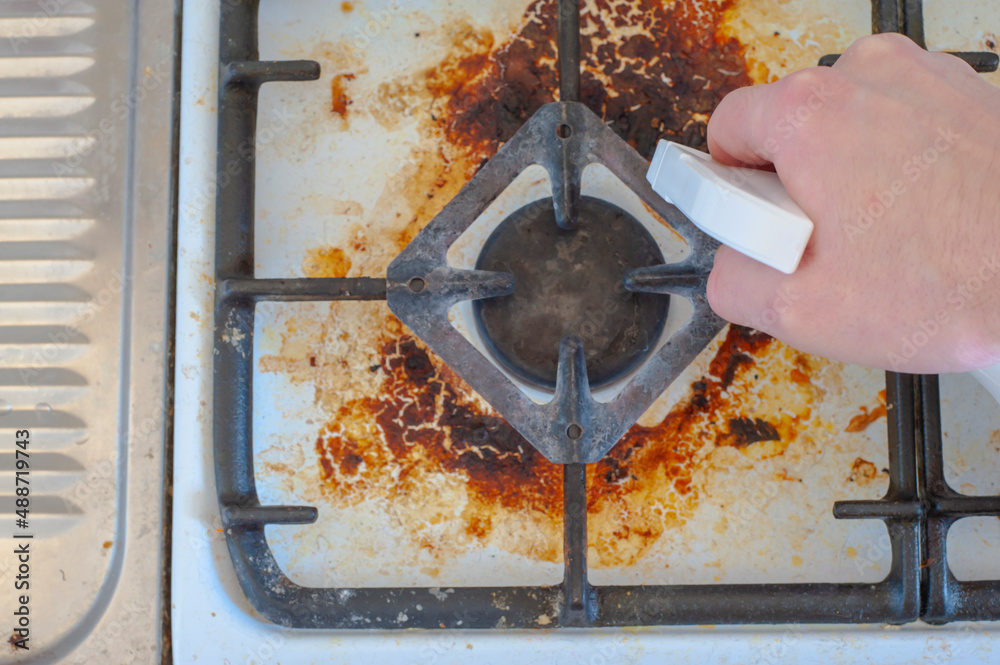 Dirty stove with food leftovers. Unclean gas kitchen cooktop with