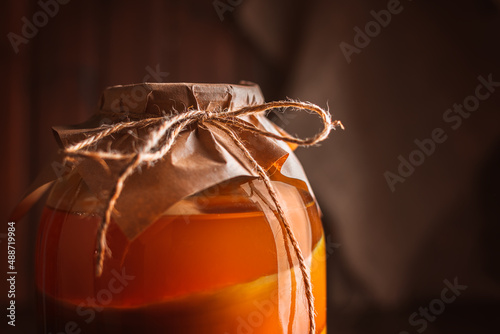 kombucha with layers in a large three-liter jar. organic healthy drink close up photo