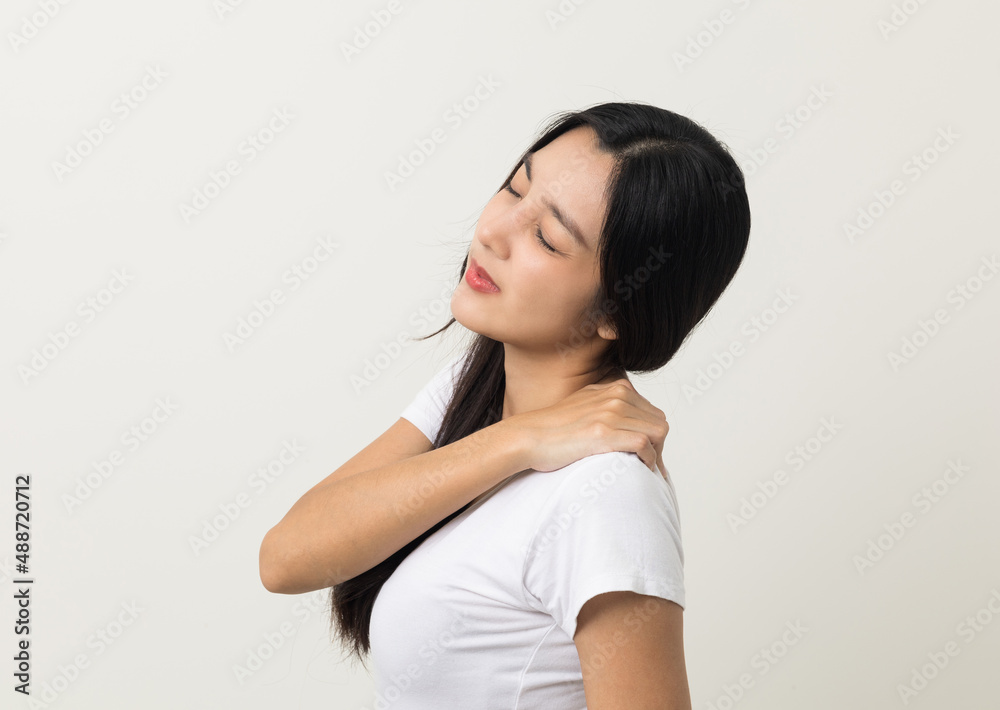 Asian woman has problem with structural posture She had neck and shoulder pain. She massaged her neck and shoulders for relief. reduce muscle tension. Standing on isolated white background Asian woman has problem with structural posture She had neck and shoulder pain. She massaged her neck and shoulders for relief. reduce muscle tension. Standing on isolated white background