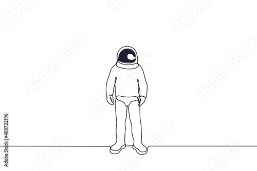 lone astronaut stands in a spacesuit with a closed helmet - one line drawing vector. cosmonautics day concept, cosmonauts clothes