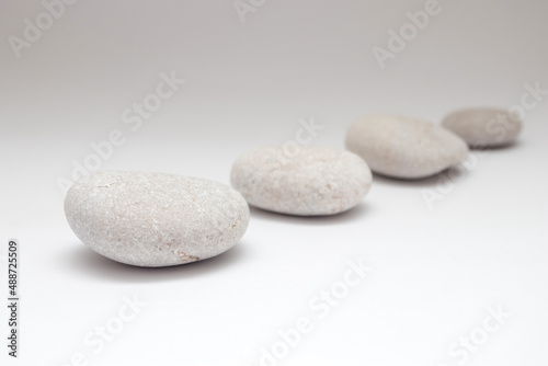 Photography a row of smooth pebbles on white background