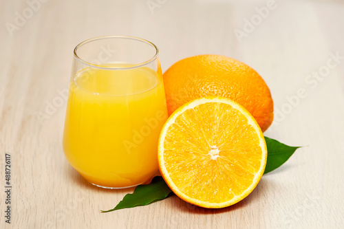 Fresh orange juice and fresh fruits on wooden table, closeup