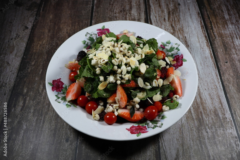 Traditional fresh and organic mixed vegetable salad serving on the plate. Mock up of luxury salad menu concept. 