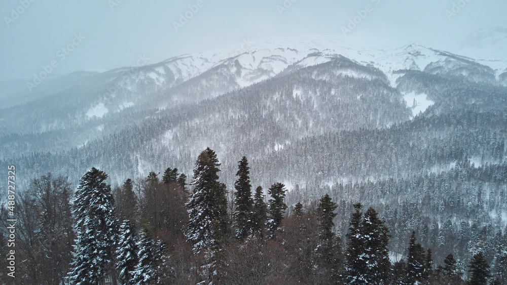 High mountains in the snow during a blizzard. Aerial view. High mountains in the snow during a blizzard. Aerial view.