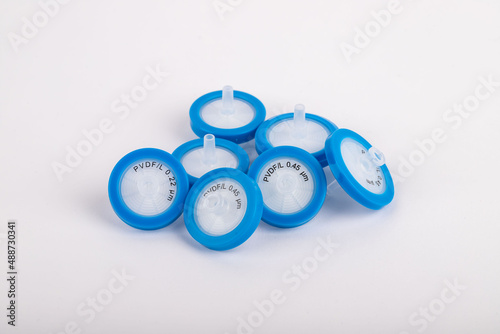 Blue needle tip filter standing on a white background. They are used in experiments in a laboratory environment.