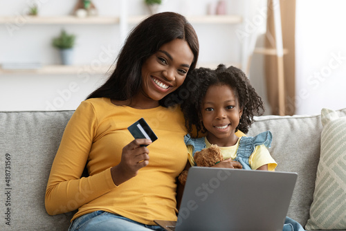 Online Payments. Black Mom And Female Child With Laptop And Credit Card