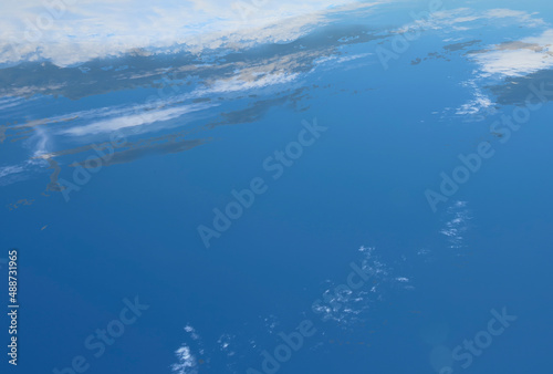 Abstract background of the view of the surface of the planet from space. Clouds  ocean and land. International day human space flight 12 April. The image was created from a photograph of the sky.