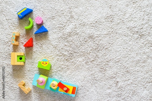Wallpaper Mural Colorful wooden pyramid with geometric details on a white cotton carpet. Eco friendly, plastic free toys for toddler. Space for text Torontodigital.ca