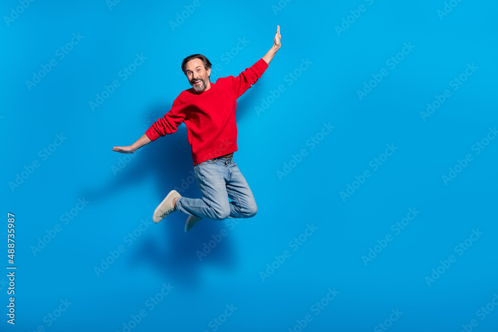 Full length body size view of attractive cheery man jumping fooling having fun isolated over bright blue color background
