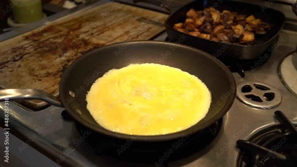 Eggs are cooked over a stove. Eggs are cooked over a stove.