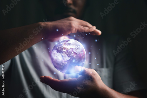 concept of future world technology By the earth in the hands of man. Earth day. Energy saving concept. Elements of this image furnished by NASA.
